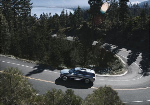 A 2023 Lincoln Aviator® SUV is being driven on a winding mountain road | Lexington Park Ford Lincoln in California MD