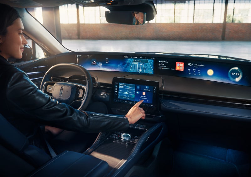 The driver of a 2024 Lincoln Nautilus® SUV interacts with the center touchscreen. | Lexington Park Ford Lincoln in California MD