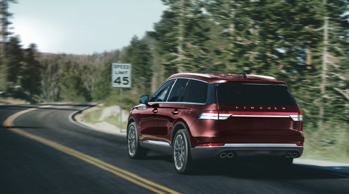 A 2024 Lincoln Aviator® SUV is being driven on a winding mountain road | Lexington Park Ford Lincoln in California MD