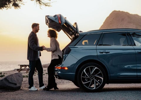 A couple share a moment together outside a 2025 Lincoln Corsair® SUV near the open liftgate. | Lexington Park Ford Lincoln in California MD