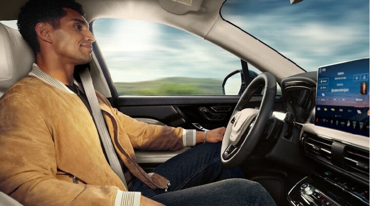 A person is shown using Lincoln BlueCruise hands-free highway driving technology on a divided highway called a Hands-Free Blue Zone. | Lexington Park Ford Lincoln in California MD