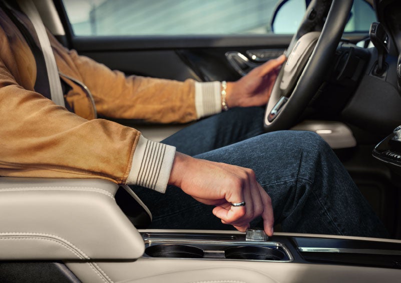 The driver of a 2024 Lincoln Corsair® SUV is shown selecting the drive mode. | Lexington Park Ford Lincoln in California MD