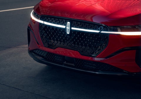 The available front LED light bar and center Lincoln Star logo glow at dusk. | Lexington Park Ford Lincoln in California MD