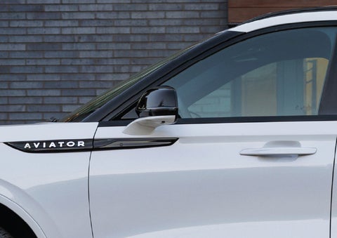 The driver’s side door and fender badging of a white 2026 Lincoln Aviator® SUV are showcased. | Lexington Park Ford Lincoln in California MD