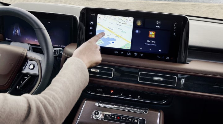 A person is tapping the center display touchscreen of a 2026 Lincoln Aviator® SUV. | Lexington Park Ford Lincoln in California MD