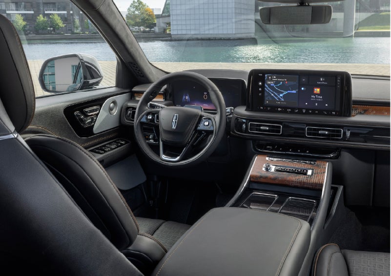The interior of the 2026 Lincoln Aviator® SUV is shown parked with a view of a harbor through the windshield. | Lexington Park Ford Lincoln in California MD