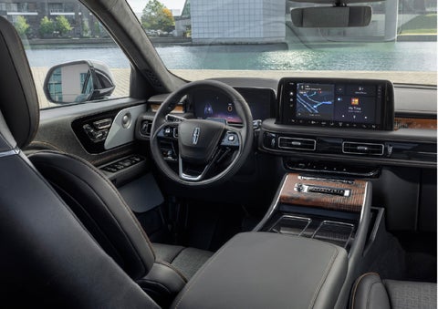 The interior of the 2026 Lincoln Aviator® SUV is shown parked with a view of a harbor through the windshield. | Lexington Park Ford Lincoln in California MD