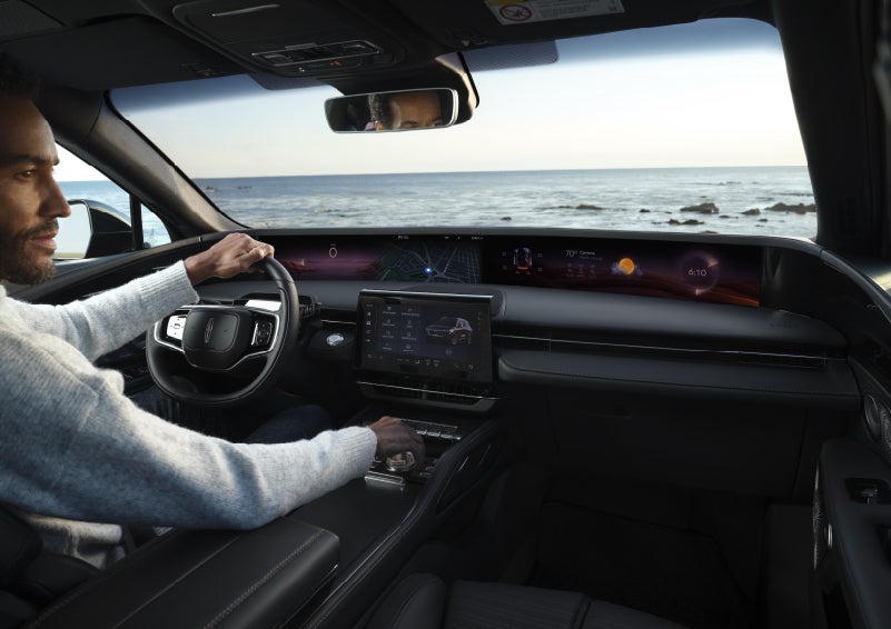 A driver of a parked 2026 Lincoln Nautilus® SUV takes a relaxing moment at a seaside overlook while inside his Nautilus. | Lexington Park Ford Lincoln in California MD