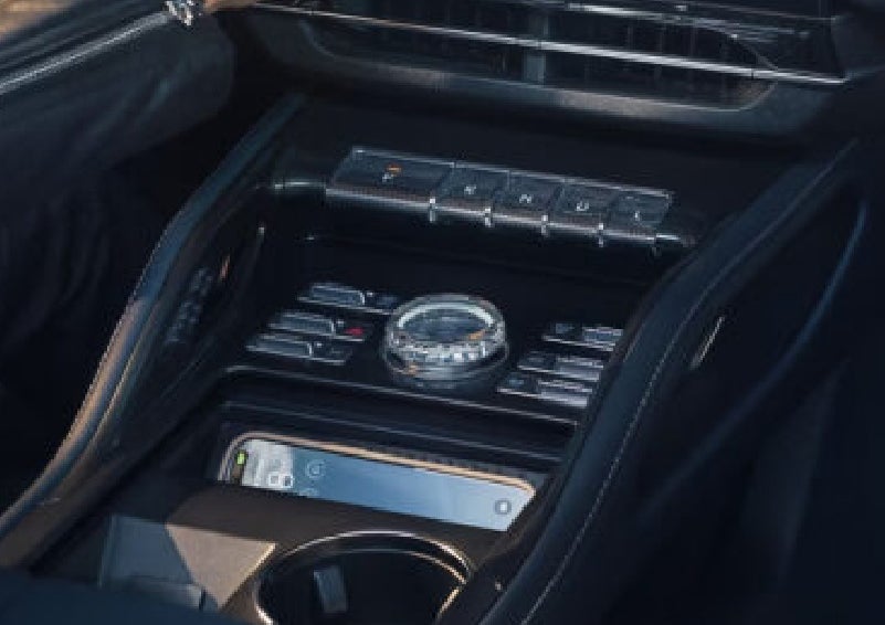 A smartphone is shown charging in the wireless charging pad. | Lexington Park Ford Lincoln in California MD