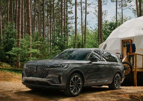 A 2027 Lincoln Aviator® is parked next to a high end glamping site. | Lexington Park Lincoln in California MD