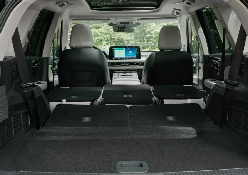 A rear to front view of the interior of a 2027 Lincoln Aviator® Black Label™ SUV shows the third and second rows folded flat | Lexington Park Lincoln in California MD