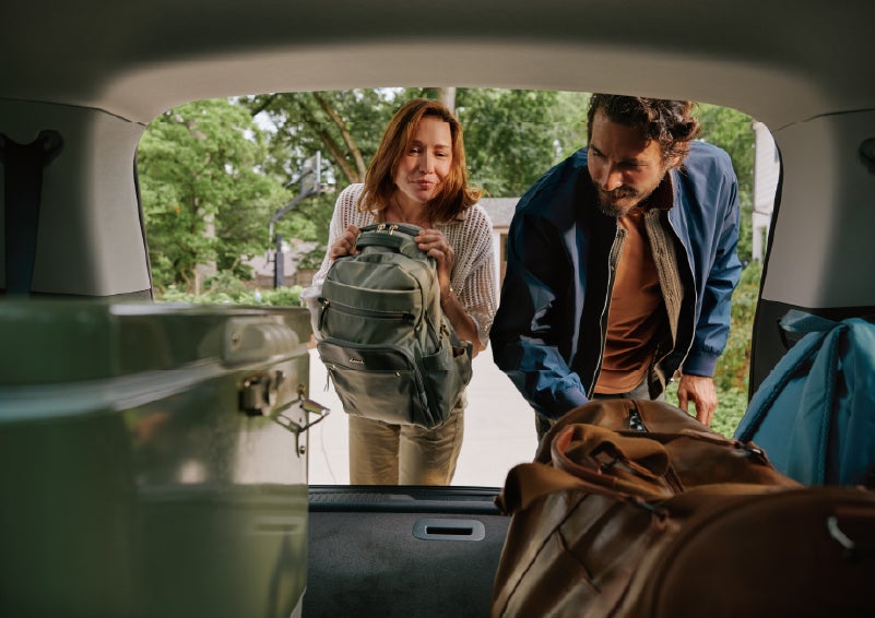 A couple loads luggage into the rear of a 2027 Lincoln Aviator® Black Label™ SUV..e 202 | Lexington Park Lincoln in California MD