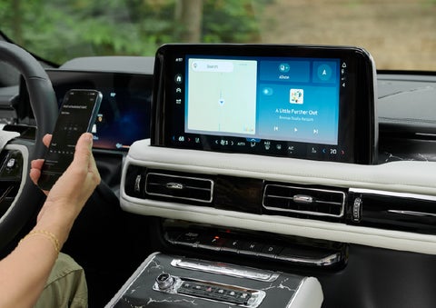 A person pairs thier phone with the center touchscreen of a 2027 Lincoln Aviator® Black Label™ SUV | Lexington Park Lincoln in California MD
